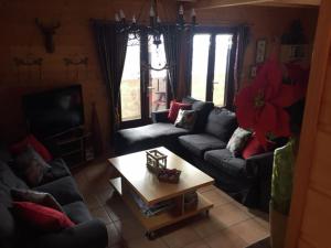 a living room with couches and a coffee table at Magnificent chalet on the mountain slopes in Les Gets