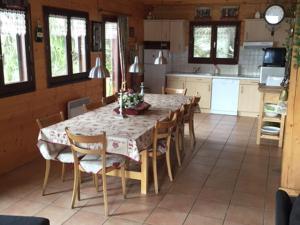 a dining room with a table and chairs in a kitchen at Magnificent chalet on the mountain slopes in Les Gets