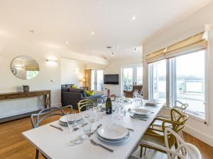 a dining room with a white table and chairs at Wrens Lake House in South Cerney +23 photos