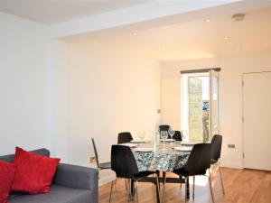a dining room with a table and chairs at Pebble Cottage in Ventnor