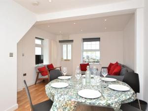 a dining room with a table and chairs at Pebble Cottage in Ventnor