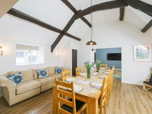 a dining room and living room with a table and a couch at Number Six - Ukc4968 in Tawstock