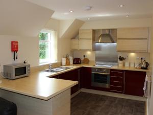 a kitchen with a sink and a microwave at Pine View in Invergarry