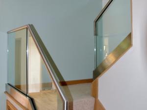 a staircase with glass railings and a white wall at Dunmore Villa-Uk36498 in Tarbert