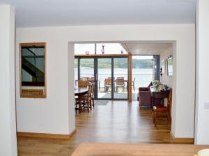 a dining room and living room with a table and chairs at Dunmore Villa-Uk36498 in Tarbert