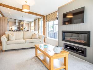 a living room with a couch and a fireplace at Rivendale 52 in St. Andrews