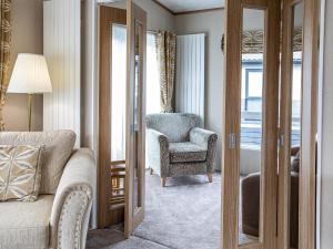 a living room with a couch and a chair at Rivendale 8 in St. Andrews