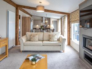 a living room with a couch and a table at Rivendale 8 in St. Andrews