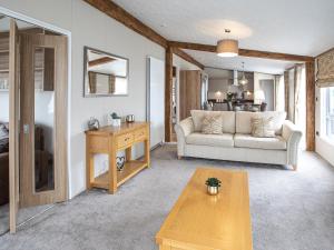 a living room with a couch and a table at Rivendale 8 in St. Andrews