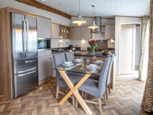 a kitchen with a table with chairs and a refrigerator at Rivendale 8 in St. Andrews +7 photos