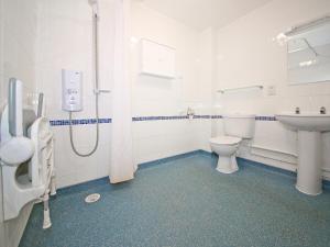 a bathroom with a toilet and a sink at Beech Cottage in Uckfield