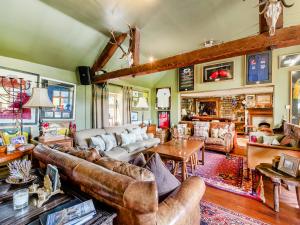 a living room with leather couches and a table at Croxton Lodge & Curlews Nest in Croxton Kerrial