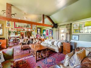 a living room with couches and a table at Croxton Lodge & Curlews Nest in Croxton Kerrial