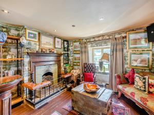 a living room with a fireplace and a couch at Croxton Lodge & Curlews Nest in Croxton Kerrial