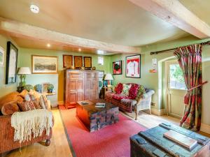 a living room with a couch and a table at Croxton Lodge & Curlews Nest in Croxton Kerrial +34 photos