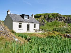 a white house on the side of a hill at Tigh Beg in Lerags