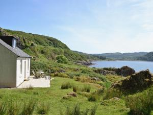 a house on a hill next to a body of water at Tigh Beg in Lerags +3 photos