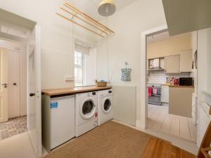 a kitchen with a washer and dryer in a room at The Lodge in Duffus +10 photos