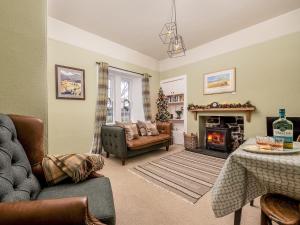 a living room with a couch and a fireplace at The Lodge in Duffus