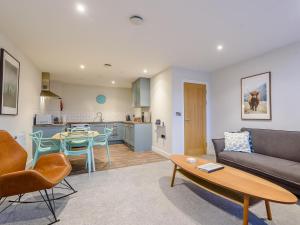 a living room with a couch and a table and a kitchen at 3 Eastgate - Uk34282 in Andover
