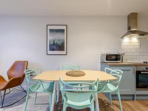 a kitchen with a wooden table and chairs at 3 Eastgate - Uk34282 in Andover