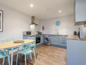 a kitchen with a table and chairs and a sink at 3 Eastgate - Uk34282 in Andover
