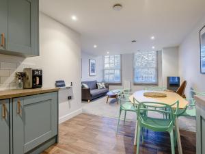 a kitchen and living room with a table and chairs at 3 Eastgate - Uk34282 in Andover +9 photos