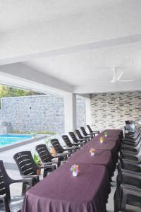 a row of tables and chairs with purple table cloth at HEMGIRI - Private Pool Villa Mulshi in Mulshi +12 photos