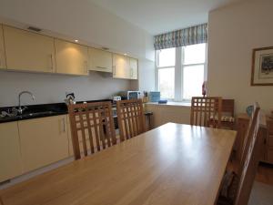 a kitchen with a large wooden table and chairs at Monastery 13 - Abbots Rest - Ukc4886 in Fort Augustus