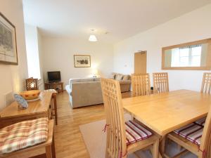 a dining room and living room with a table and chairs at Monastery 13 - Abbots Rest - Ukc4886 in Fort Augustus