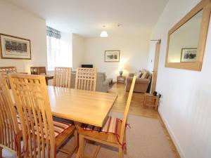 a dining room and living room with a table and chairs at Monastery 13 - Abbots Rest - Ukc4886 in Fort Augustus