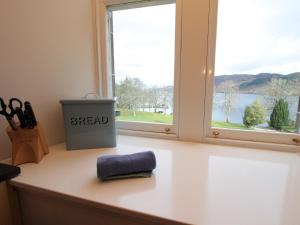 a counter with a window with a heap of scissors at Monastery 13 - Abbots Rest - Ukc4886 in Fort Augustus +13 photos