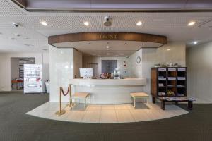 a store with a counter and chairs in a room at Mito Hotel Season in Mito
