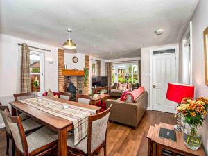 a living room with a table and a couch at Mountain View-Ukc5060 in Aviemore