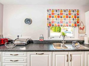 a kitchen counter with a sink and a window at Mountain View-Ukc5060 in Aviemore