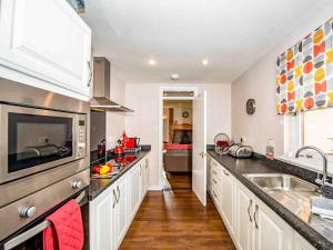 a kitchen with a sink and a counter top at Mountain View-Ukc5060 in Aviemore