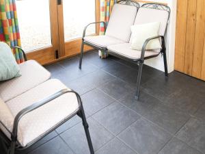 a room with two chairs and a couch at Acorn Cottage in Ashover +12 photos