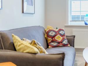 a couch with two pillows and a blanket on it at 4 Eastgate - Uk34281 in Andover