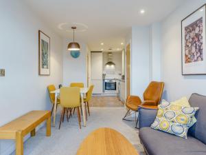 a living room with a couch and a table and chairs at 4 Eastgate - Uk34281 in Andover