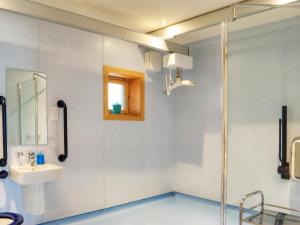 a bathroom with a shower and a sink and a mirror at Homelands-Cardy in Lundin Links