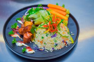 a plate of food with rice and vegetables on it at Mistara Ella in Ella