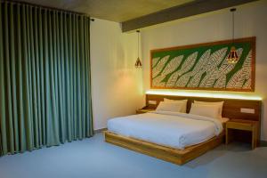 a bedroom with a bed and a large window at Mistara Ella in Ella +67 photos