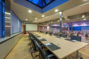 a large conference room with long tables and chairs at Hotel Falko in Meise