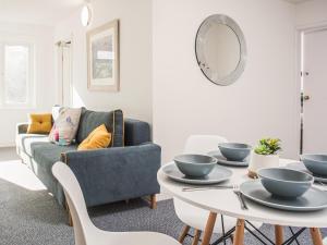 a living room with a couch and a table at Newport House Lower in Newport