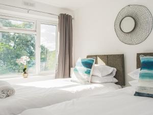 a bedroom with two beds and a window at Newport House Lower in Newport +7 photos