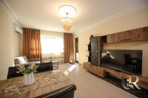 a living room with a large flat screen tv at Apartments Rivera in Dobrich