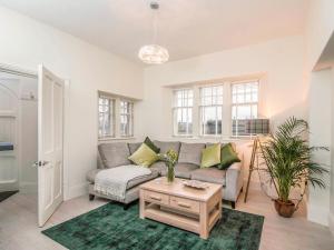 a living room with a couch and a table at Firlands Lodge - Ukc6205 in Nairn