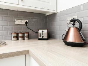 a tea kettle on a counter in a kitchen at Firlands Lodge - Ukc6205 in Nairn