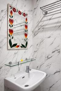 a white bathroom with a sink and a mirror at Puri Anyar Ubud by Puri Signatures in Ubud +72 photos