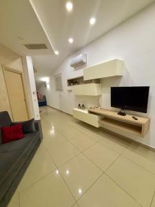 a living room with a flat screen tv on a wall at Casa vacanza Helios in Leonforte
